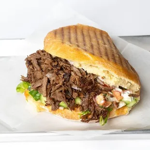 Halal, Grass-Fed Beef or Chicken seasoned with special herbs and spices, wrapped in homemade warm bread and served with veggies and sauces.