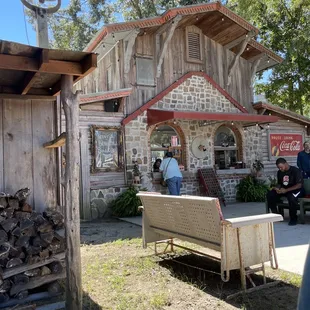 a man sitting on a bench in front of a building