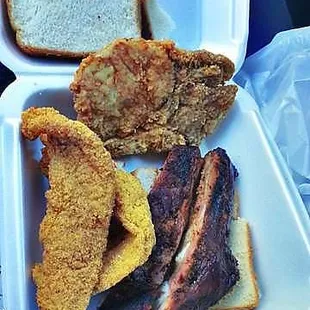 a tray of meat, bread, and a sandwich