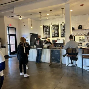 people standing at counter and waiting for customers