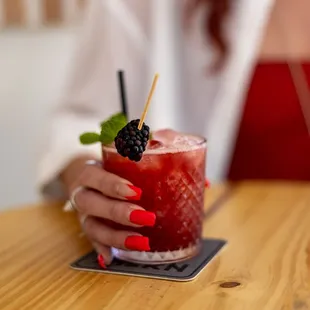 a woman holding a drink