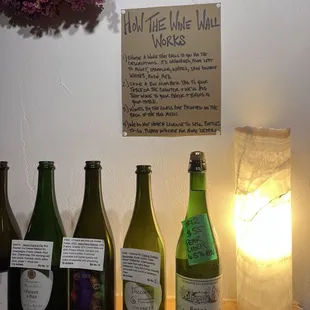 You can choose a bottle from the wall and drink that at your table but you can't buy it to take home