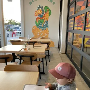 a child sitting at a table in a restaurant