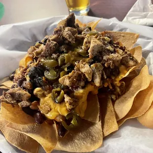 Chili cheese nachos topped with chicken. Yummy!