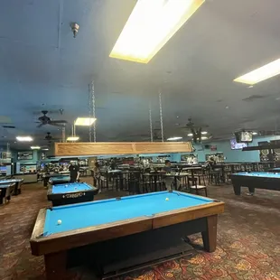 a billiards room with pool tables
