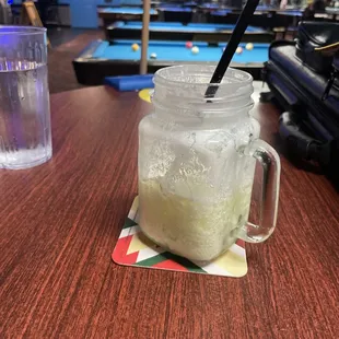 a drink in a mason jar on a table