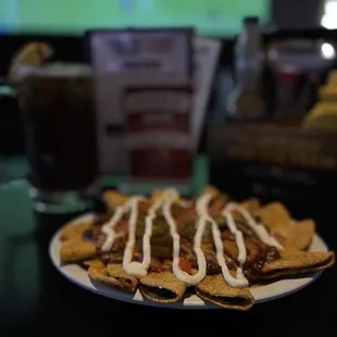 CP Nachos!!! mini chicken tacos, smothered in chili and cheese, then top with tomatoes, onions, jalapeños, and sour cream!