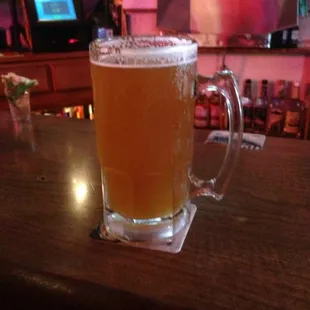 a glass of beer on a bar