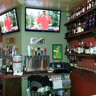 a bar with two televisions on the wall