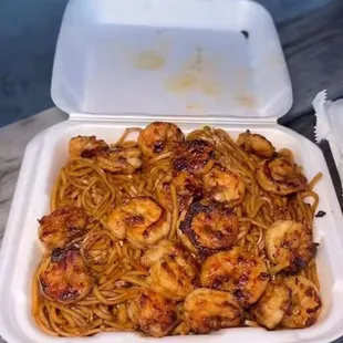 a container of shrimp and noodles