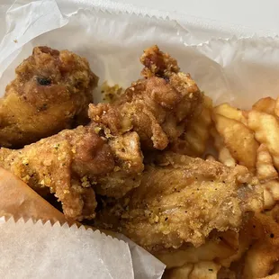 a basket of fried chicken and french fries