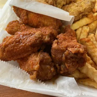 a tray of fried chicken and french fries