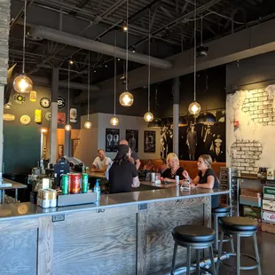 people sitting at a bar in a restaurant