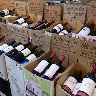 a variety of wine bottles in cardboard boxes