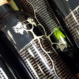 three bottles of wine on a shelf