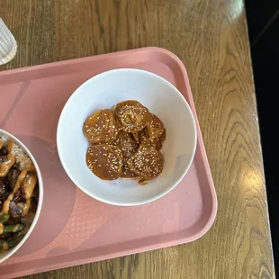 a bowl of food on a pink tray