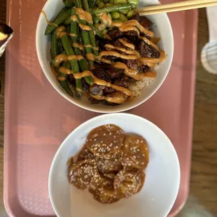 two bowls of food on a pink tray