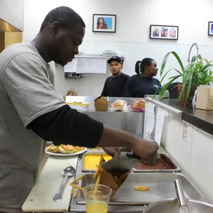 A youth plating food.