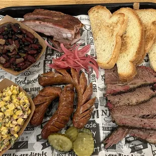 Corn salad, baked beans, ribs, sausage, brisket and toast!