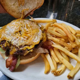 Bacon Cheeseburger with fries (opened up so u can see the inside. Bf loved it. Big sized juicy patty