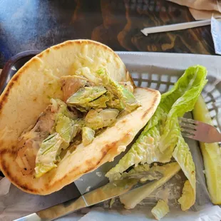 Avocado chicken pita. I removed the large leaf of romaine  so I could chop it up to eat. Asked for tomato.