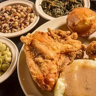 a plate of fried chicken, mashed potatoes, gravy, mashed beans, mashed potatoes, mashed