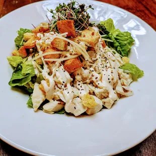 Caesar Salad with House made Dressing. Features Grilled Chicken Breast, Bacon and Parmesan Cheese.