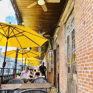 a group of people sitting under yellow umbrellas