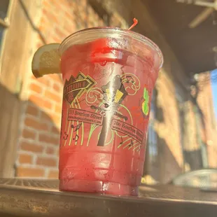 a drink in a plastic cup on a table