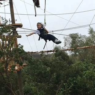 My three year old son flying down one of the many zip lines. He loved this place!