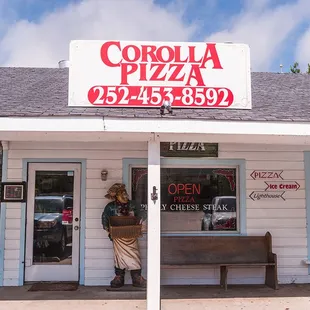 Corolla Pizza &amp; Deli store front next to Winks Gas Station in Corolla, NC.
