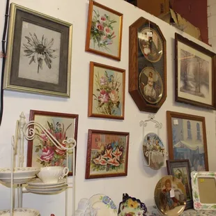 A cute display of their pictures, frames, and plates for sale!