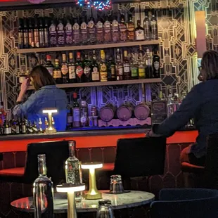 two people sitting at a bar