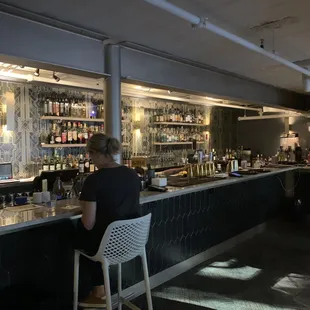 a woman sitting at a bar