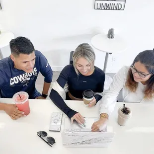 three people sitting at a table