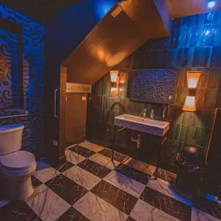 a toilet and sink in a dimly lit bathroom