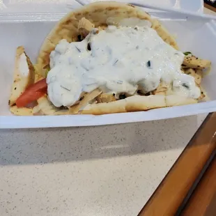 a chicken pita in a styrofoam container