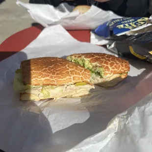 Tuna melt on Dutch crunch roll with avocado.