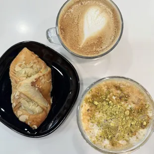 Almond croissant, caffe latte, and cold brew with pistachio foam