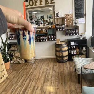 a hand holding a cup of coffee