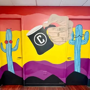 Bathrooms featuring a cool mural by Judith Aram.