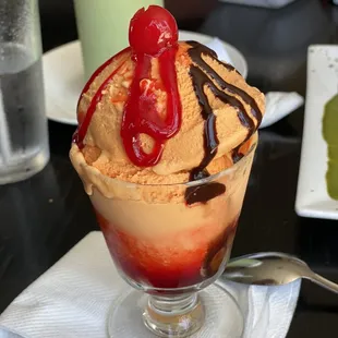 Julianna made this Lucama ice cream with customized hot fudge n strawberry topping and cherry on the top.