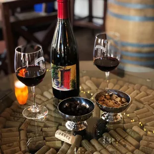 a glass of wine and corks