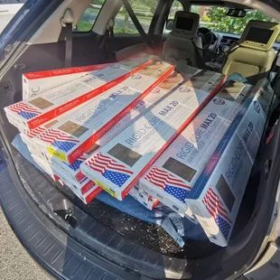 the trunk of a car filled with boxes of mail