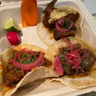 three tacos in a styrofoam container