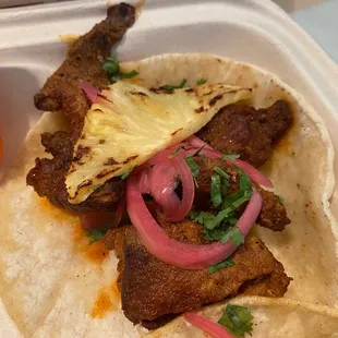 a taco with meat and onions