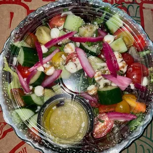 Nonno's Garden Salad: cucumbers, cherry tomatoes, pickled onions, mozzarella balls, Italian dressing + balsamic glaze 100/10
