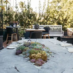 Enjoy sips &amp; snacks at our planted table on the patio.
