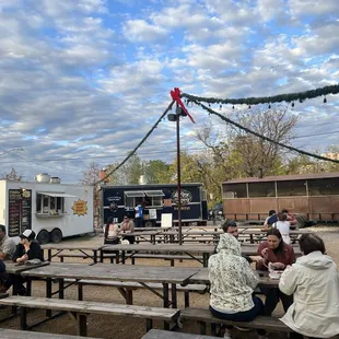 Outdoor seating with food trucks