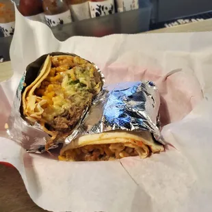 two burritos wrapped in foil